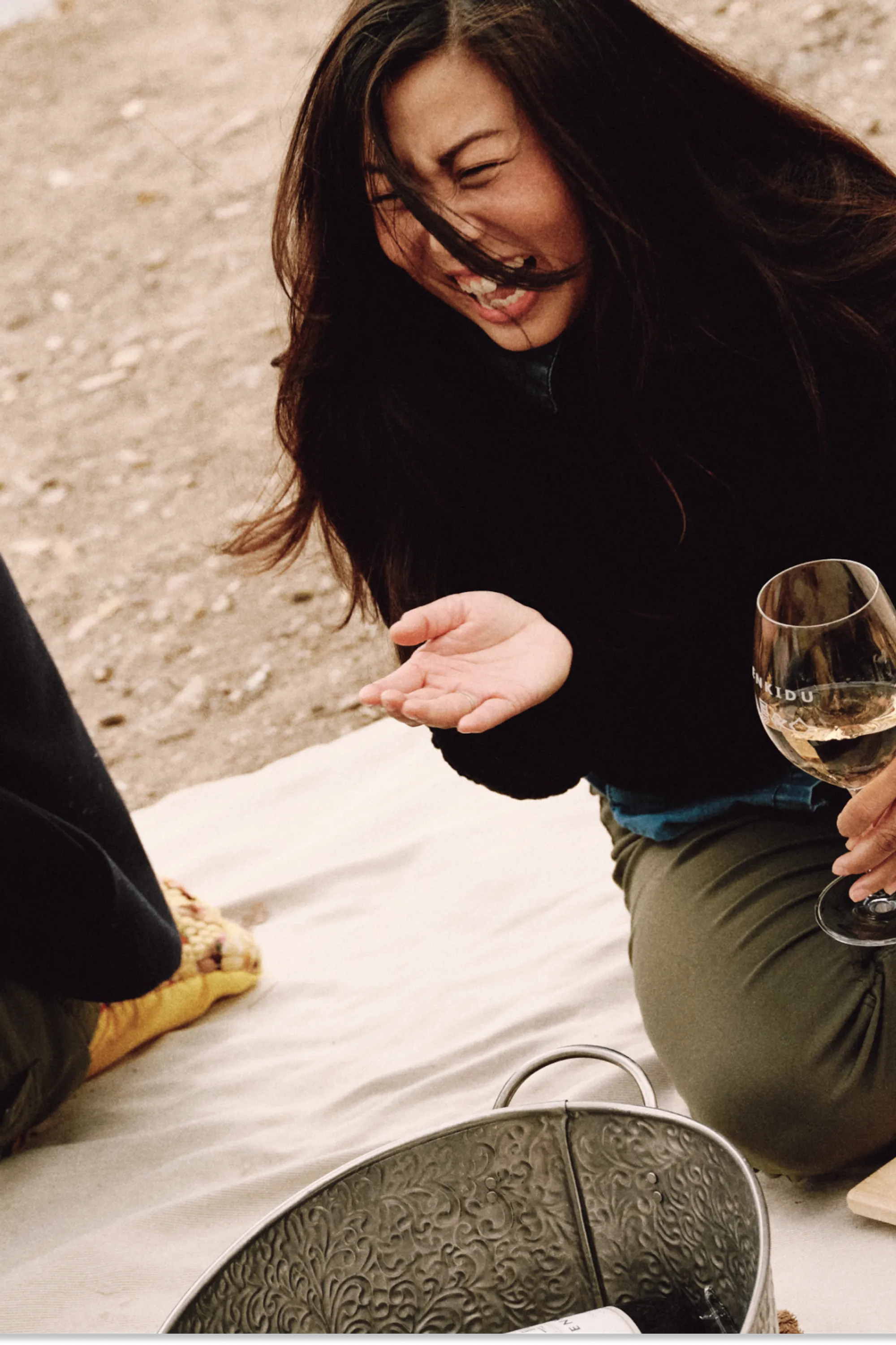 Friends laughing together and drinking wine