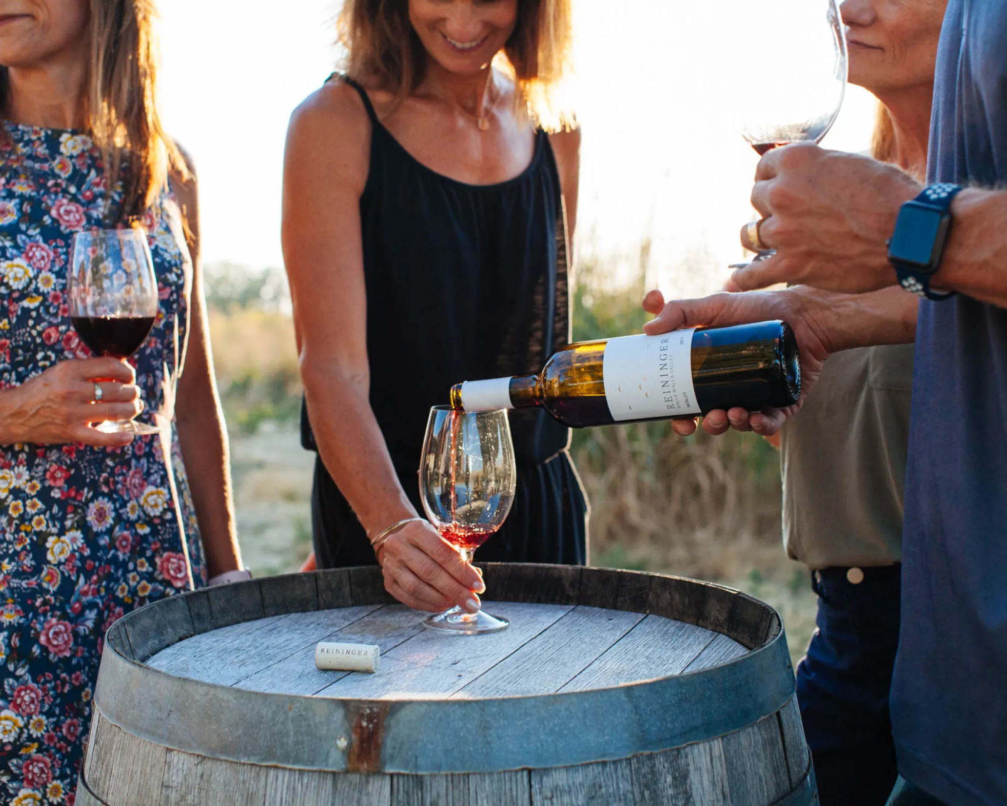 Woman being poured a glass of red wine