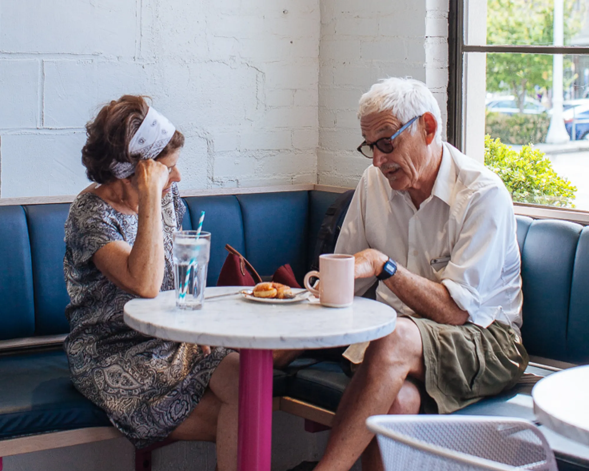 Older couple enjoying their drinks at a table at Sea Creatures