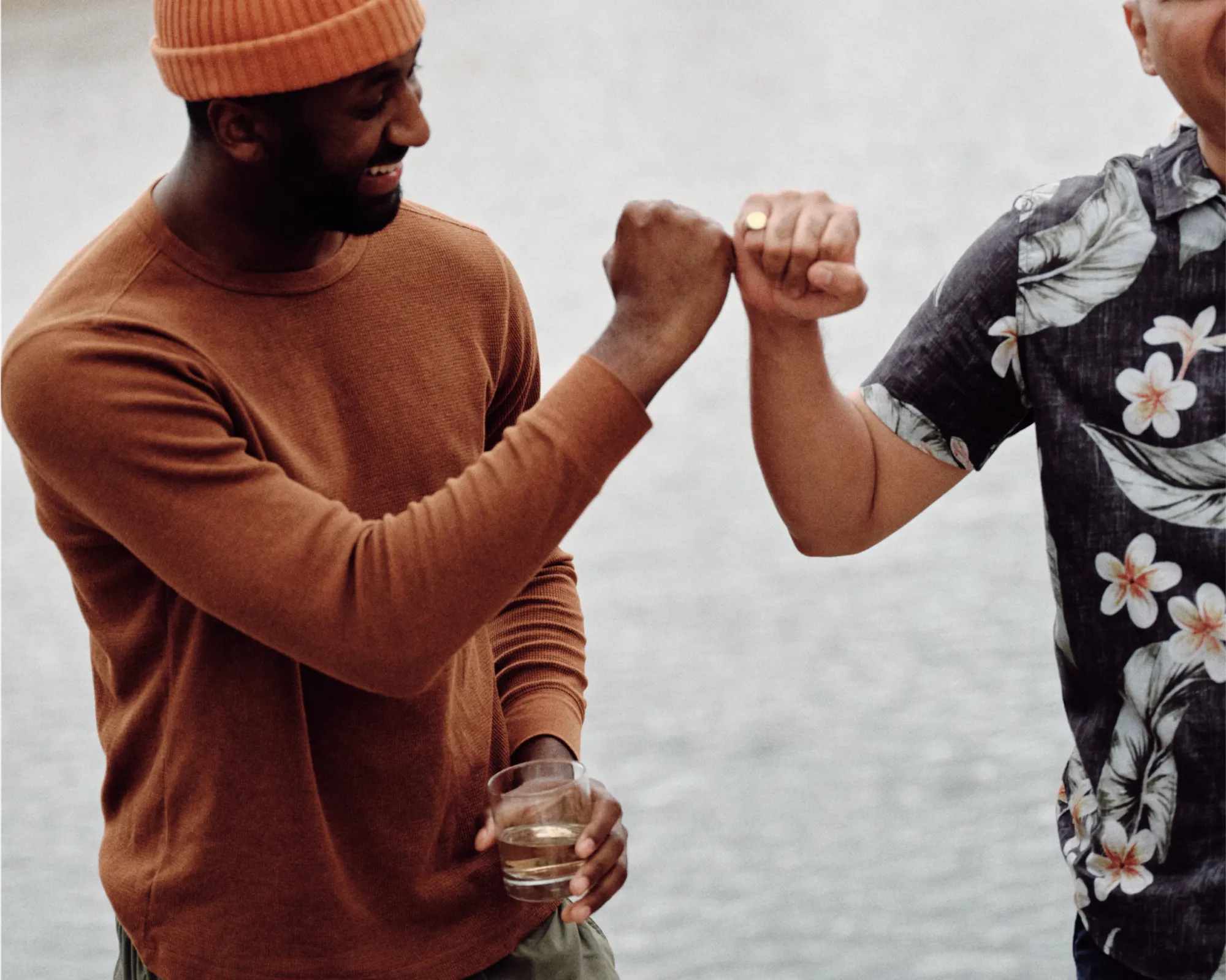 Friends fist-bumping and drinking wine